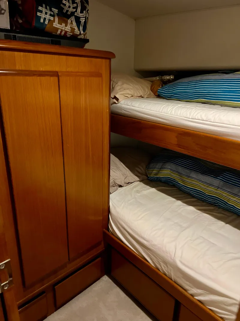 Slide: The Image of Bunk beds and wooden wardrobe in 1997 Viking 43 Convertible yacht cabin. - 60