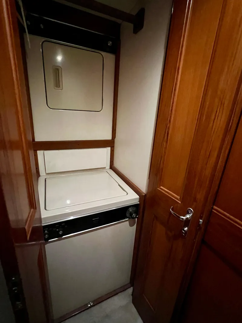 Slide: The Image of Laundry area with washer and dryer in 1997 Viking 43 Convertible yacht. - 63