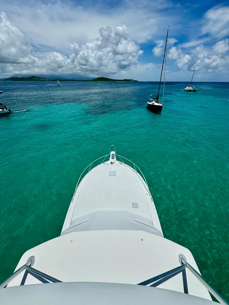 Slide: The Image of Bow view of 1997 Viking 43 Convertible yacht on turquoise sea under blue sky. - 7