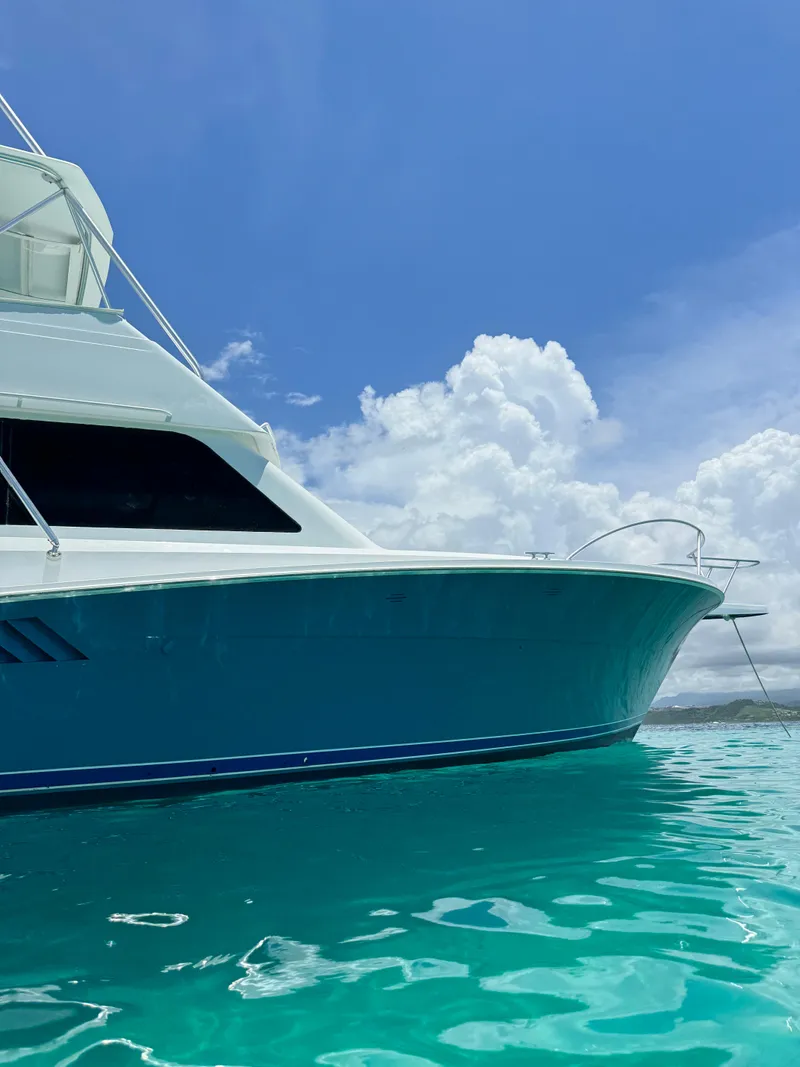 Slide: The Image of 1997 Viking 43 Convertible yacht on turquoise water under blue sky. - 9