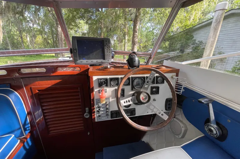 Slide: The Image of 1979 Skiff Craft Hard Top Cruiser helm with navigation equipment and wooden dashboard. - 15