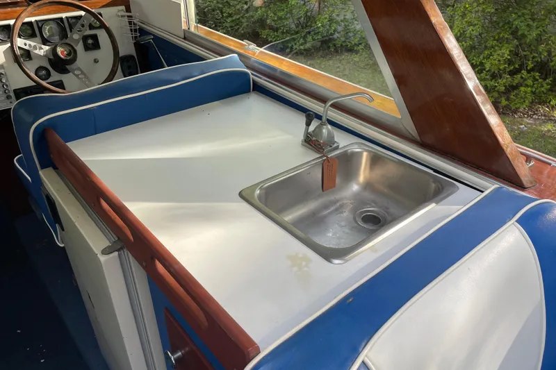 Slide: The Image of 1979 Skiff Craft Hard Top Cruiser interior with sink and steering wheel. - 17