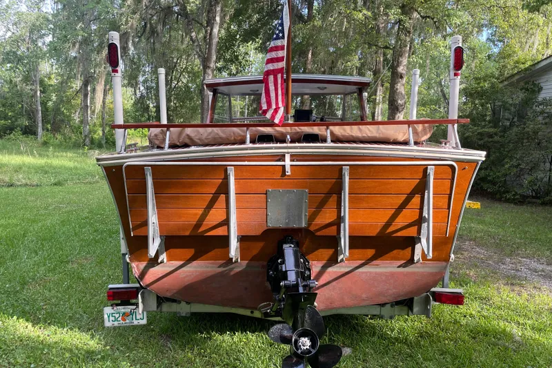 Slide: The Image of 1979 Skiff Craft Hard Top Cruiser with American flag, rear view. - 25