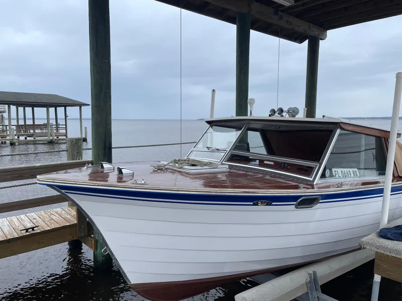 Slide: The Image of 1979 Skiff Craft Hard Top Cruiser docked under a covered pier. - 6
