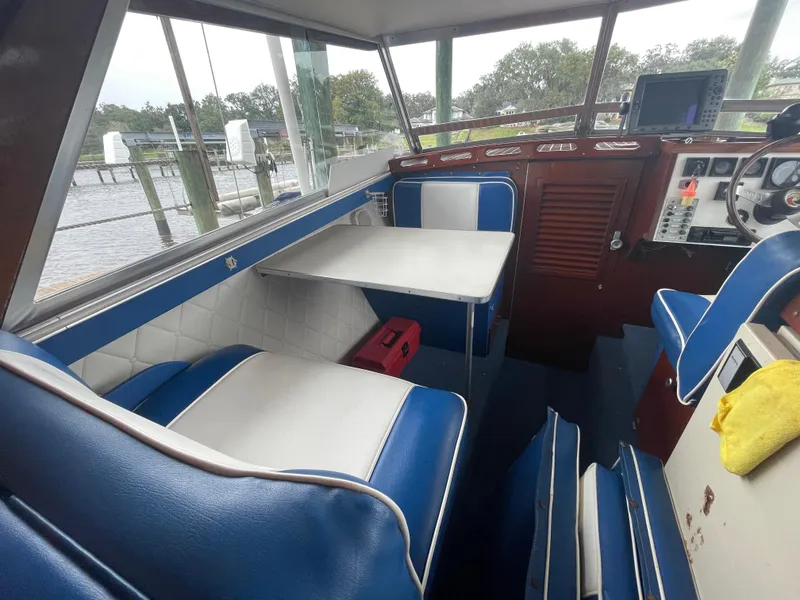 Slide: The Image of 1979 Skiff Craft Hard Top Cruiser interior with blue and white seating and table. - 7