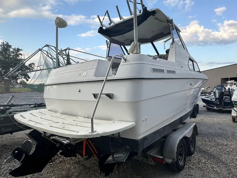 Slide: The Image of 1998 Bayliner 2452 Ciera Express boat on a trailer, rear view. - 2