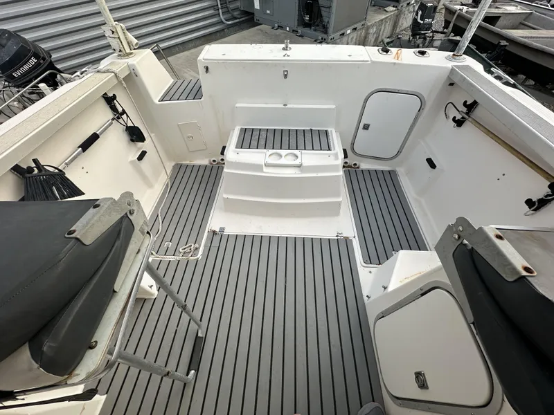 Slide: The Image of 1998 Bayliner 2452 Ciera Express boat interior with seating and storage compartments. - 4