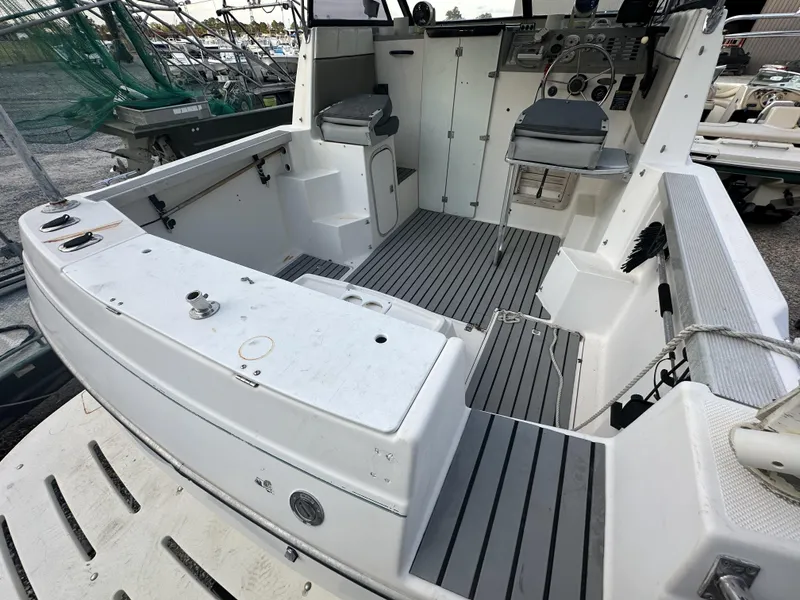 Slide: The Image of 1998 Bayliner 2452 Ciera Express boat interior with seating and control panel. - 9