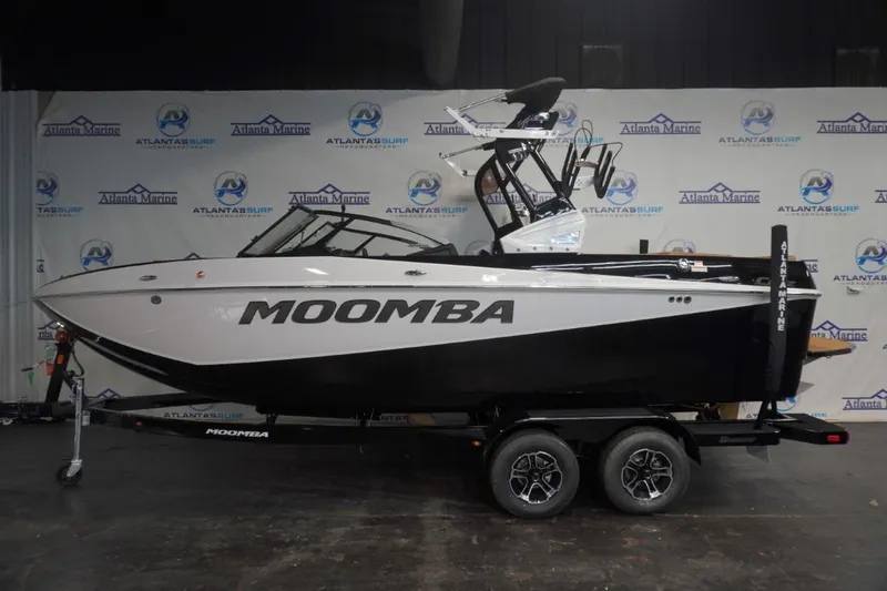 The Image of A 2024 Moomba Craz boat on a trailer in a showroom. - 1