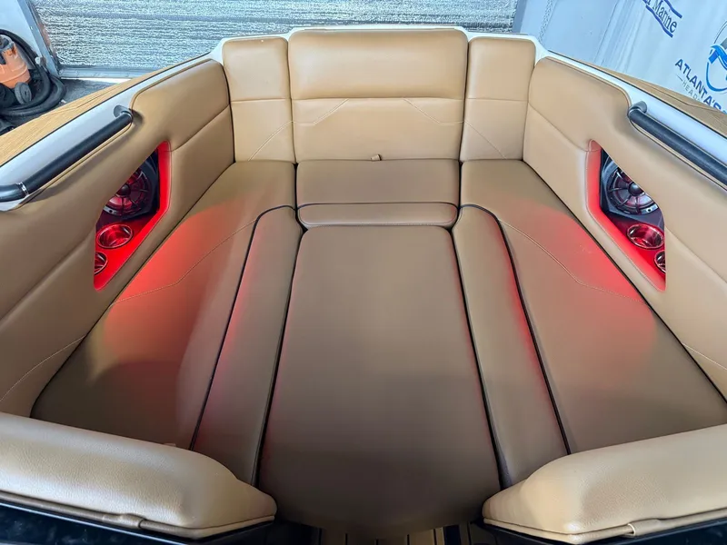 Slide: The Image of Interior of a 2024 Moomba Mojo with beige upholstery and red lighting. - 24