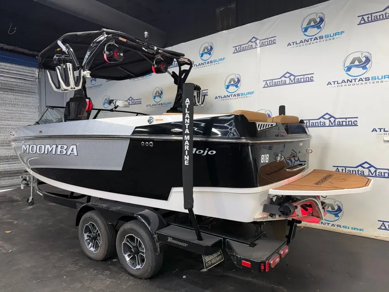 Slide: The Image of A 2024 Moomba Mojo boat is on a trailer in a showroom. - 5