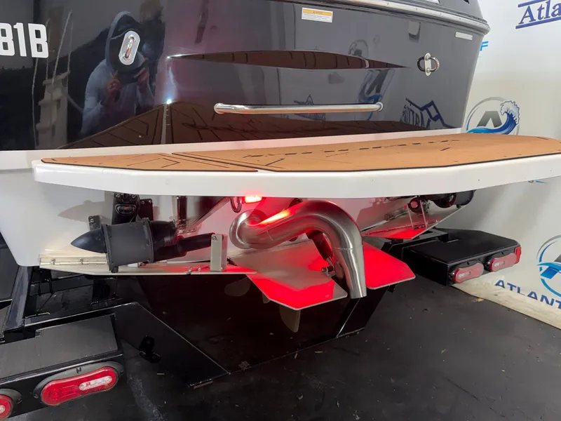 Slide: The Image of The image shows the rear of a 2024 Moomba Mojo boat with a red light. - 8
