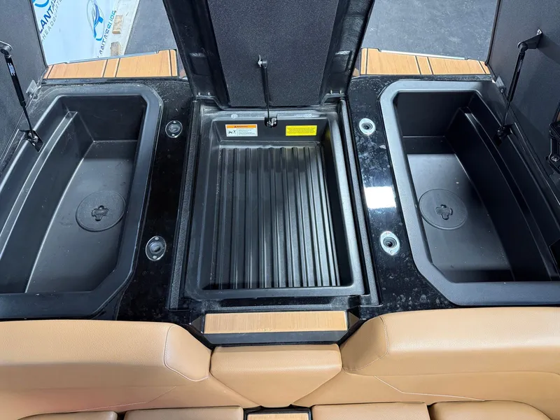 Slide: The Image of The image shows the storage area of a 2024 Moomba Mojo boat with three compartments. - 28
