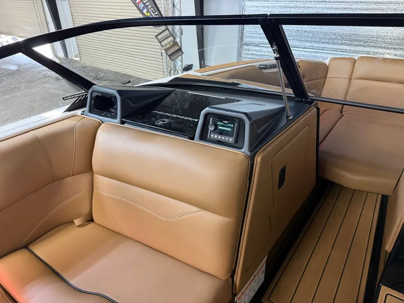 Slide: The Image of Interior of a 2024 Moomba Mojo with brown leather seats and a modern dashboard. - 23