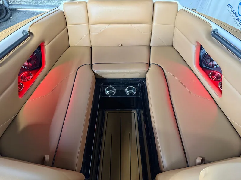 Slide: The Image of Interior of a 2024 Moomba Mojo with beige upholstery and red lighting. - 25