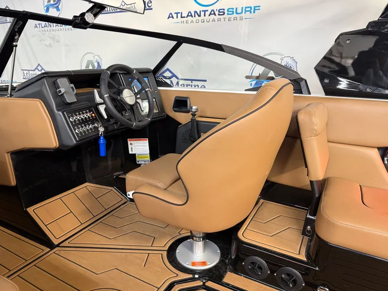 Slide: The Image of Interior of a 2024 Moomba Mojo with brown leather seats and a modern dashboard. - 19