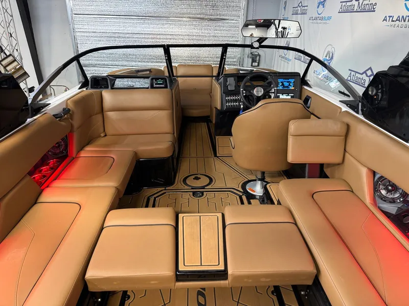 Slide: The Image of Interior of a 2024 Moomba Mojo with beige seating and red lighting. - 16