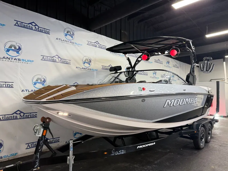 Slide: The Image of 2024 Moomba Mojo in a showroom, on a trailer, featuring modern design and equipment. - 3