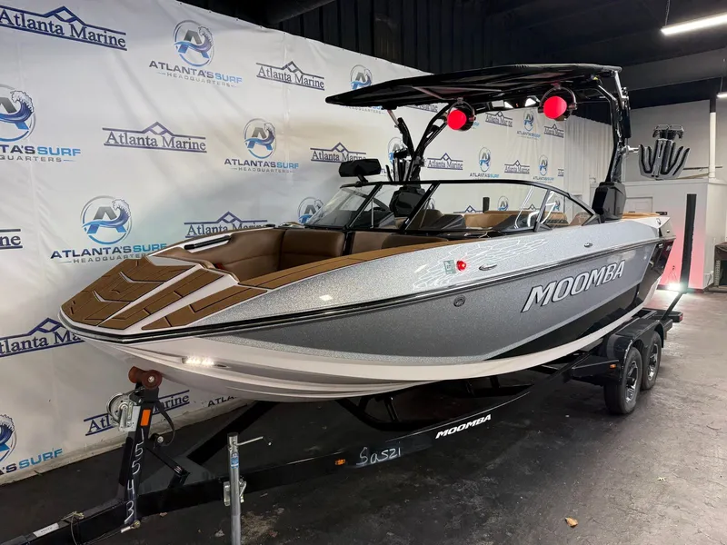 Slide: The Image of A 2024 Moomba Mojo boat is on a trailer in a showroom. - 4