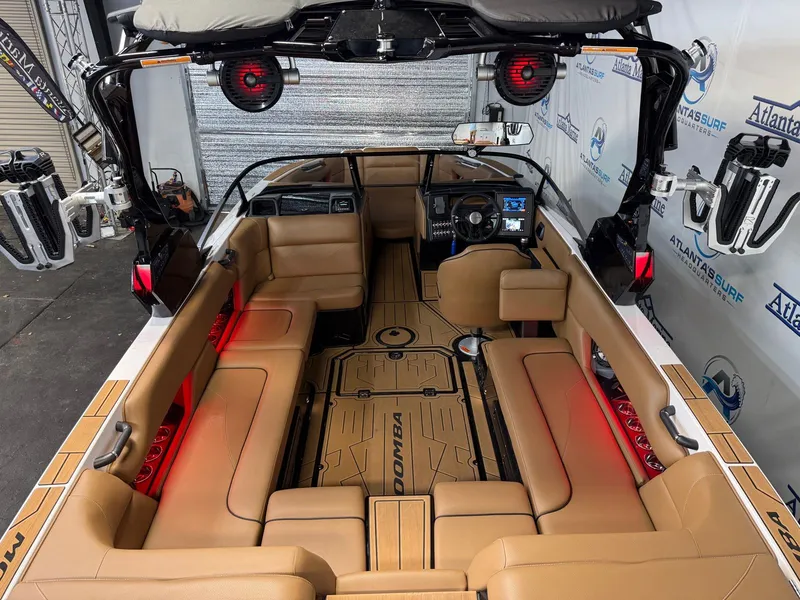 Slide: The Image of Interior view of a 2024 Moomba Mojo with brown leather seating and modern dashboard. - 12