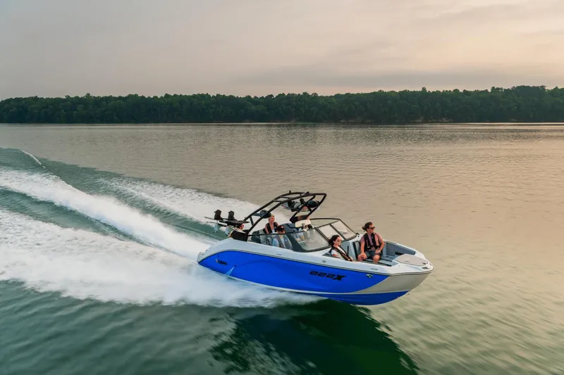 Slide: The Image of 2024 Yamaha Boats 222XD speeding on a lake with passengers. - 0