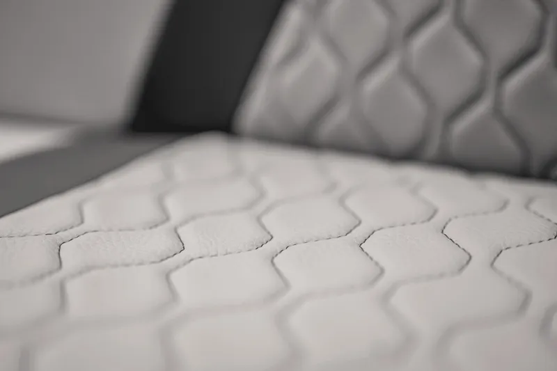 Slide: The Image of Close-up of 2024 Yamaha Boats 222XD seat with hexagonal stitching pattern. - 23