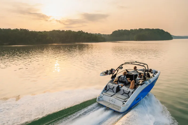 Slide: The Image of 2024 Yamaha Boats 222XD cruising on a serene lake at sunset. - 3