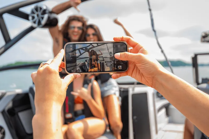 Slide: The Image of Friends taking a selfie on a 2024 Yamaha Boats 222XD. - 38