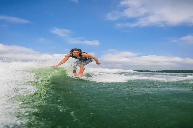 Slide: The Image of Person wakesurfing behind a 2024 Yamaha Boats 222XD on a sunny day. - 39