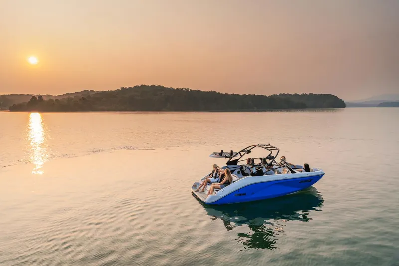Slide: The Image of 2024 Yamaha Boats 222XD on serene lake at sunset. - 4
