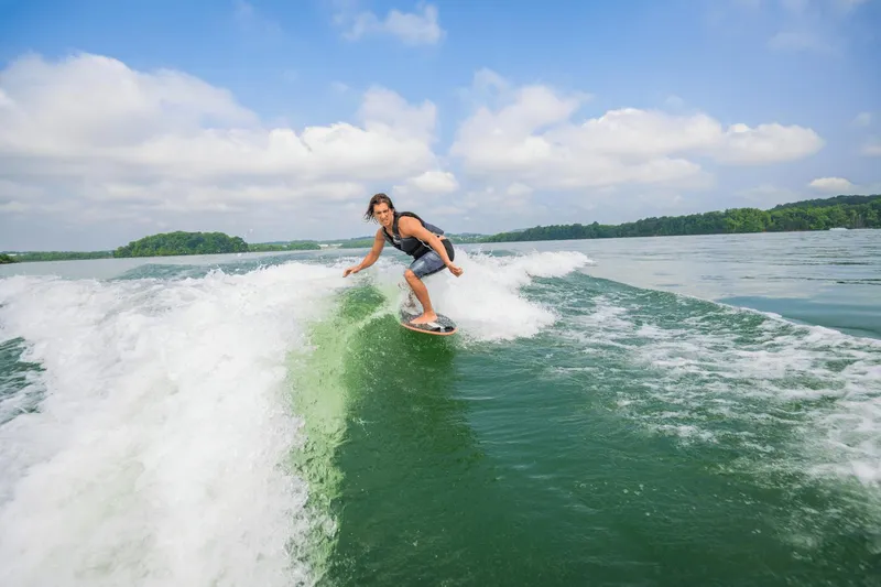 Slide: The Image of Person wakesurfing behind a 2024 Yamaha Boats 222XD on a sunny day. - 40