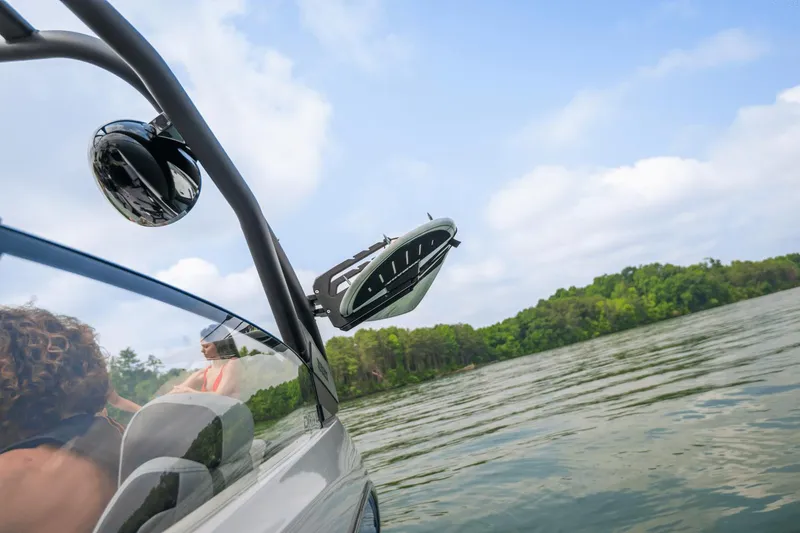 Slide: The Image of 2024 Yamaha Boats 222XD on a scenic lake with passengers. - 42