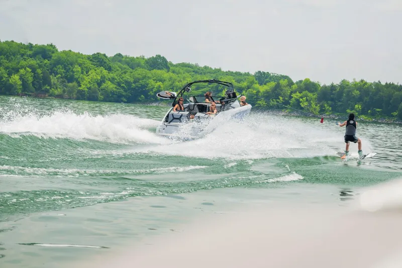 Slide: The Image of 2024 Yamaha Boats 222XD towing a wakeboarder on a lake. - 44