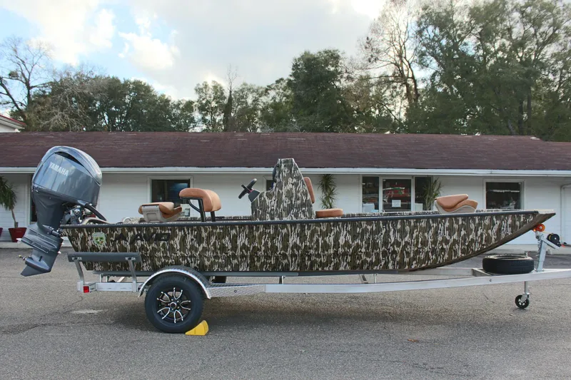 Slide: The Image of 2024 Avid 20 Rogue boat with camouflage design on a trailer. - 12