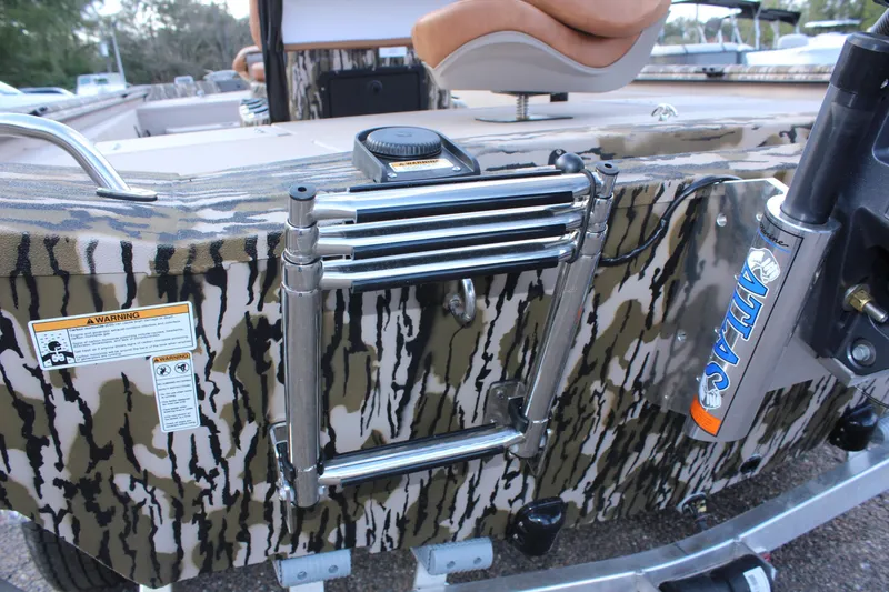 Slide: The Image of 2024 Avid 20 Rogue boat with camouflage design and foldable ladder. - 17