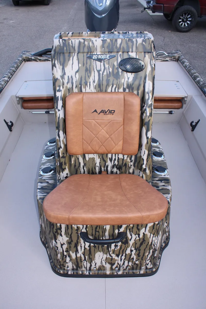 Slide: The Image of 2024 Avid 20 Rogue boat with camo seating and tan cushions. - 28