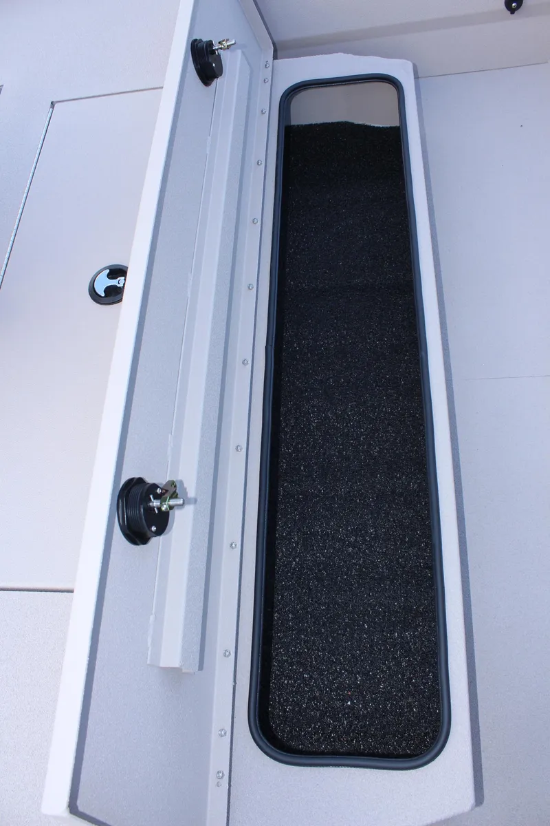 Slide: The Image of 2024 Avid 20 Rogue boat storage compartment with black interior lining. - 34