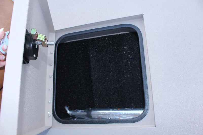 Slide: The Image of 2024 Avid 20 Rogue storage compartment with secure latch. - 37