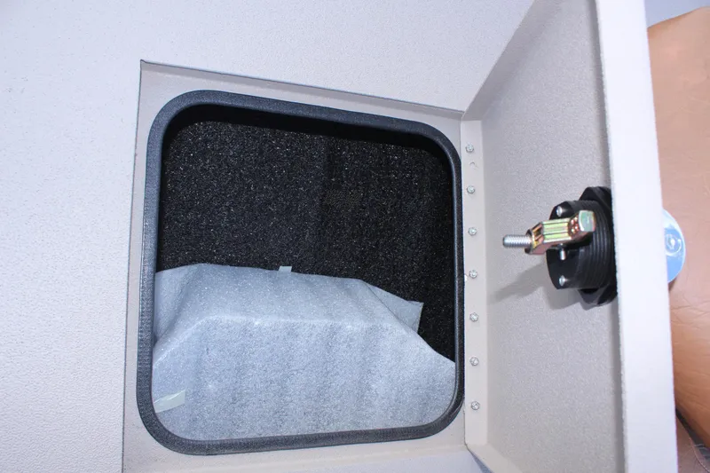 Slide: The Image of 2024 Avid 20 Rogue interior storage compartment with latch. - 38