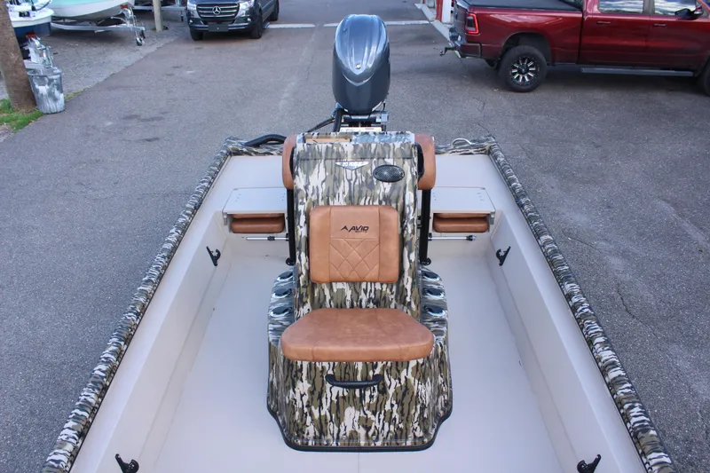 Slide: The Image of 2024 Avid 20 Rogue boat with camo seating and outboard motor. - 39
