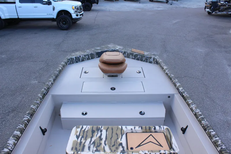 Slide: The Image of 2024 Avid 20 Rogue boat interior with camo accents and seating. - 40