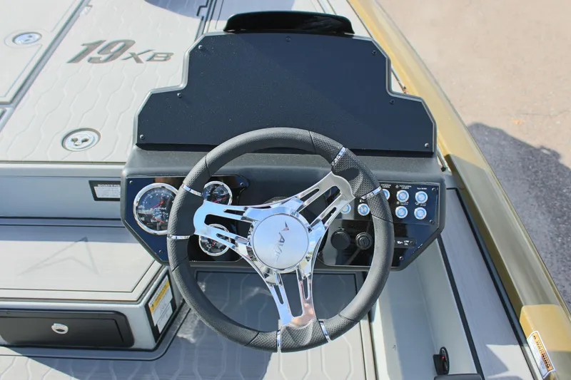 Slide: The Image of 2024 Avid 19 XB boat dashboard and steering wheel. - 15