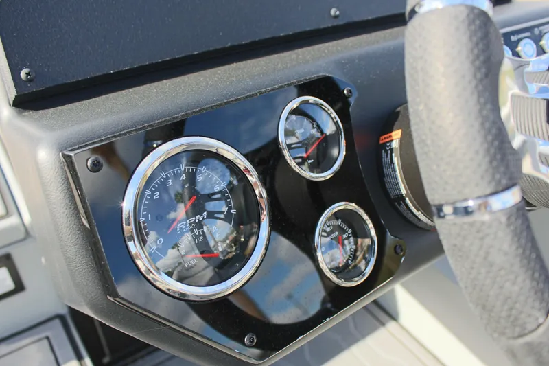 Slide: The Image of Close-up of 2024 Avid 19 XB boat dashboard with gauges and steering wheel. - 17