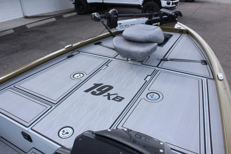 Slide: The Image of 2024 Avid 19 XB fishing boat deck with seating and storage compartments. - 25