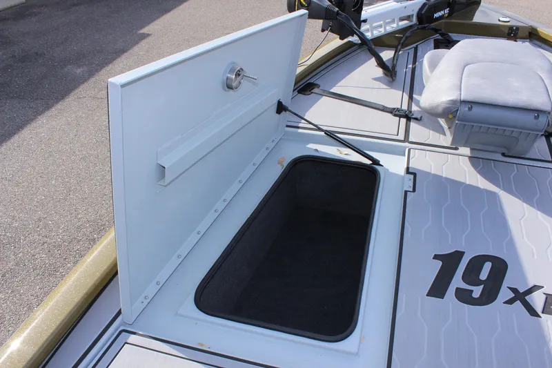 Slide: The Image of 2024 Avid 19 XB boat storage compartment with open lid. - 29