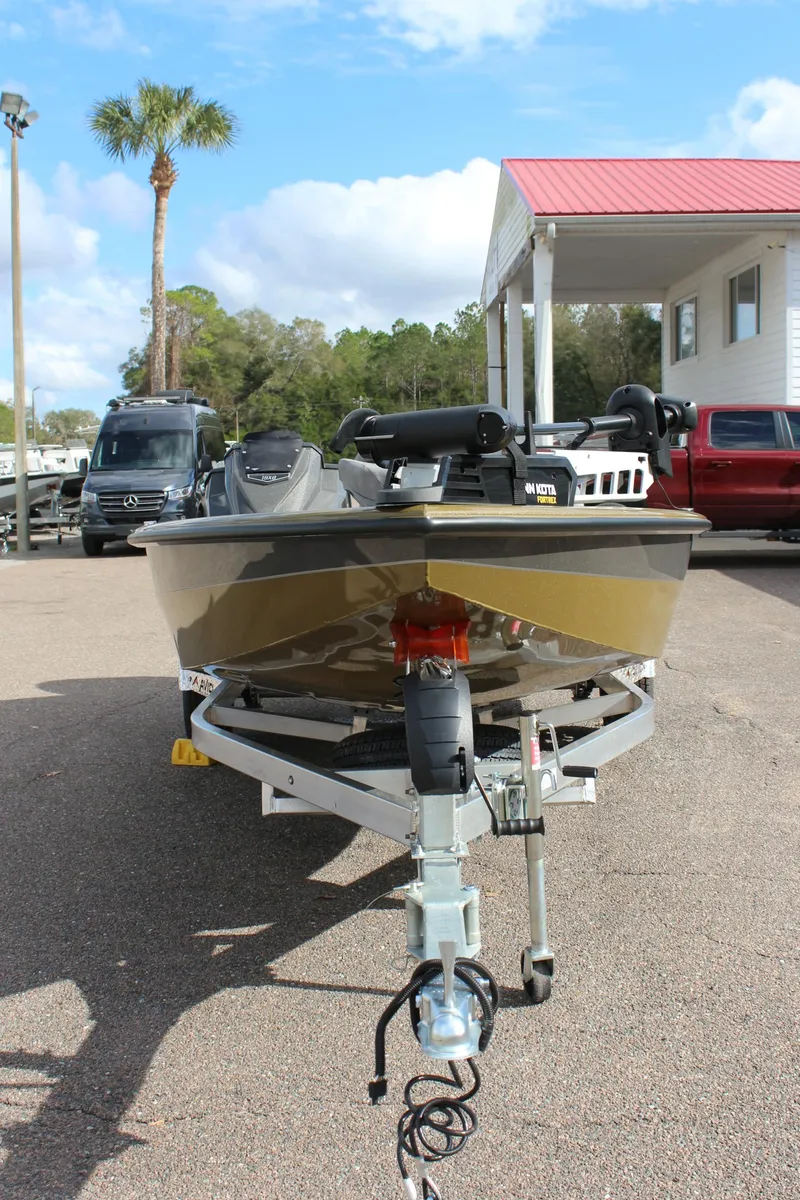 Slide: The Image of 2024 Avid 19 XB boat on trailer in outdoor dealership lot. - 3