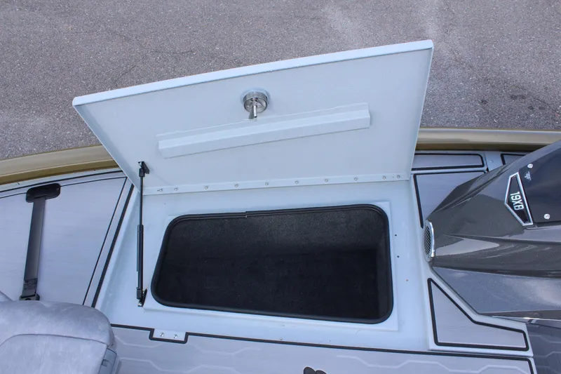 Slide: The Image of 2024 Avid 19 XB boat storage compartment with open lid. - 30