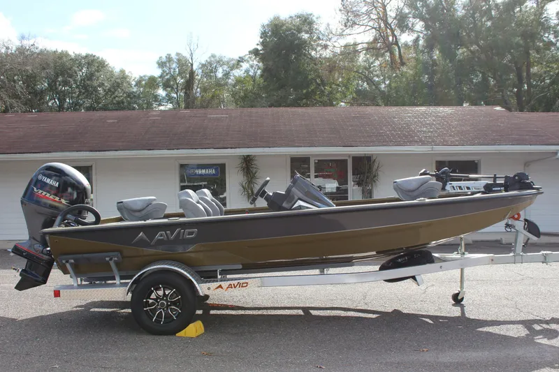 Slide: The Image of 2024 Avid 19 XB boat on trailer, parked outside a building. - 5