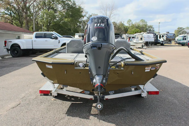 Slide: The Image of 2024 Avid 19 XB boat with 115 HP engine on trailer in parking lot. - 7