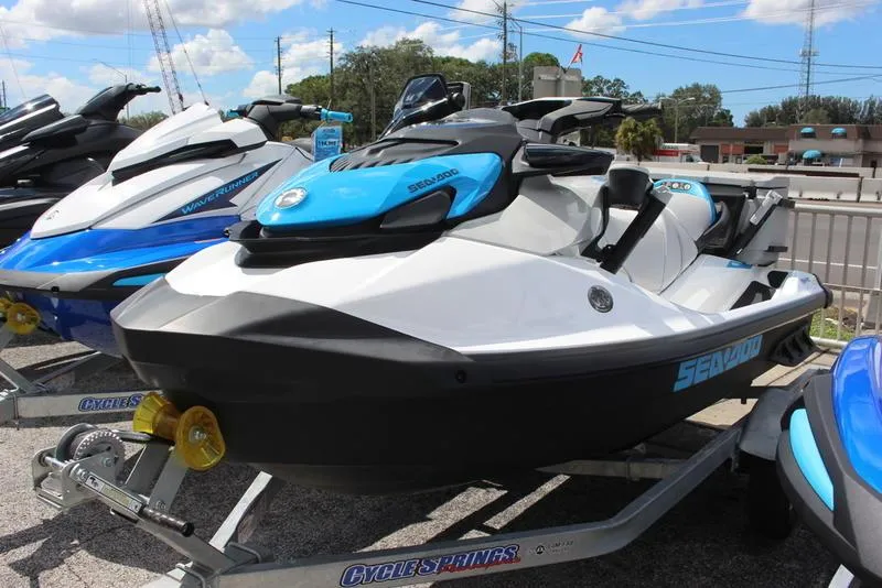 Slide: The Image of 2023 Sea-Doo Fish Pro Scout jet ski on trailer in dealership lot. - 1